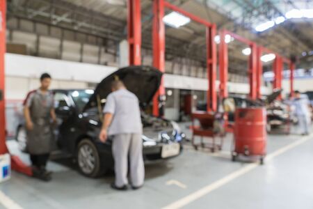 Blurred of car technician repairing the car in garage background.の写真素材