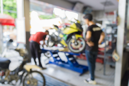 Blurred of car technician repairing the car in garage background.の写真素材