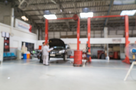 Blurred of car technician repairing the car in garage background.の写真素材