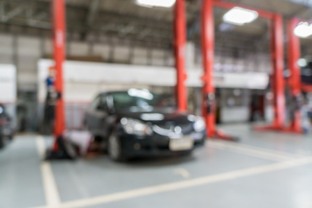 Blurred of car technician repairing the car in garage background.の写真素材