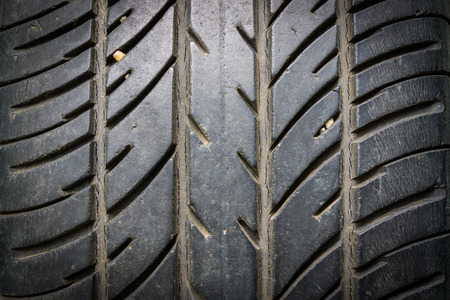 used car tire isolated on black background.の写真素材