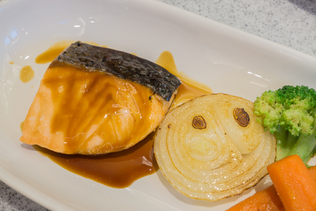 salmon steak with greensの写真素材
