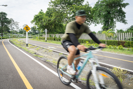 Bicycle road sign on asphalt. Leisure activitiesb,Bicycle road sign and bike rider.の写真素材