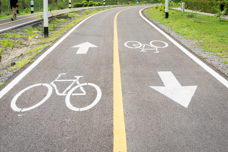 Bicycle road sign on asphalt. Leisure activitiesb,Bicycle road sign and bike rider.の写真素材