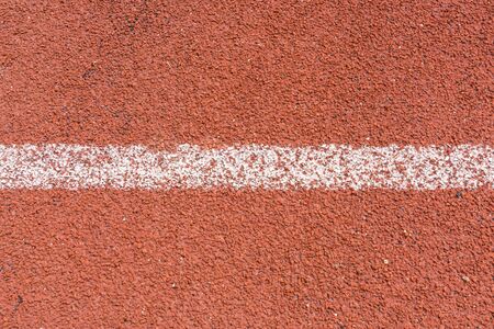 Red running tracks in sport stadium background.の写真素材
