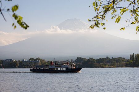 FUJI-KAWAGUCHIKO, JAPAN - October 17 ,2014 : Mountain Fuji and lake kawaguchiko with fisherman on the boat
, Japan on october14 ,2015. Mountain Fuji and lake kawaguchiko., snow-capped Mount Fuji with clear sky backgroundのeditorial素材