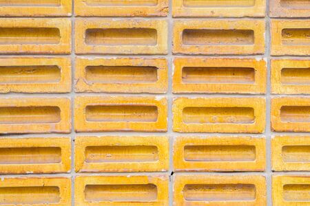 Background of yellow color old vintage brick wallの写真素材