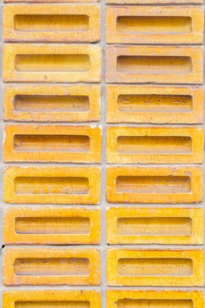 Background of yellow color old vintage brick wallの写真素材