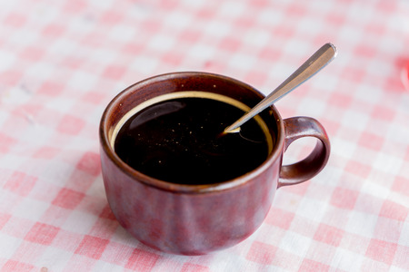 Black coffee on the vintage woven background.の写真素材