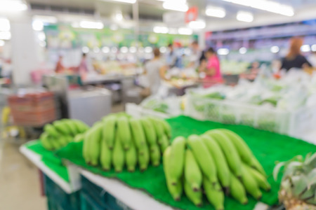 Blurred abstract background of people shopping in super market  : Shoppers in grocery store in a gangway : Walkway with full with goods and products on shelves in super marketの写真素材