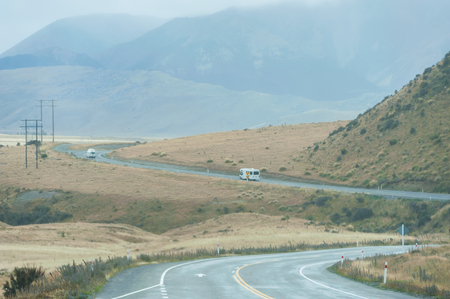 QUEENSTOWN, NEW ZEALAND - November 1: Tourists driving in New Zealand country road on a rainy dayon November 1, 2014 in Queenstown, New Zealand.のeditorial素材