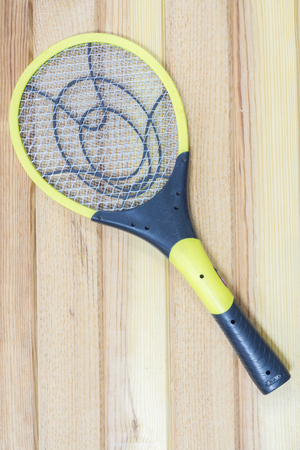 Electronic mosquitoes killer swatter  on  wooden backgroundの写真素材