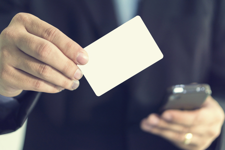 businessman showing business card ,Man's hand showing business card ,closeup shot,selective focus.の写真素材