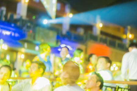 blurred background of night bokeh light,People in night club. Dancing, drinking and having fun,vintage colorの写真素材