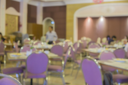 blur eating in the cafeteria,blur people sitting on seat in dining room with bokeh