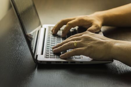 Close Up Of A Man Shopping Online Using Laptop With Credit Card,male hands holding credit card...