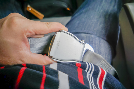 Close-up of women fastening security belt in airplane.selective focus.の写真素材