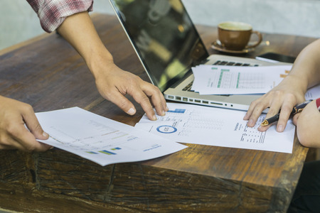 Business people discussing business strategy on the foreground, business partners hands during discussion of financial and business documents meeting Analizing  Financial Data and Charts in the Officeの写真素材