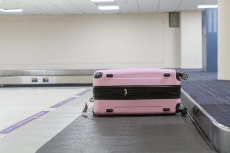 Baggage claim at the airport,suitcases on a luggage band on the airport,Baggage on conveyor belt at the airport - selective focus,vintage colorの写真素材
