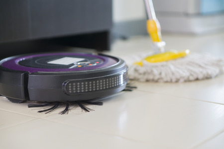 floor washing robot VS traditional mop on laminate floor,selective focusの写真素材