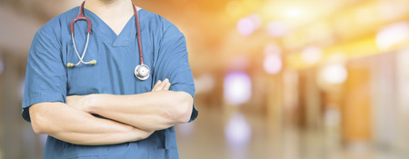Medical Doctor surgeon posing with arms crossed in an operating theatre,surgical room,doctor with operating room,healthcare and medical concept,stethoscope,healtcare ,background bannerの写真素材