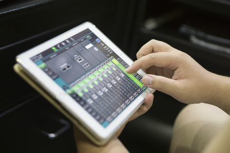 studio working with sound and light mixer console,hands of sound engineer working on recording...