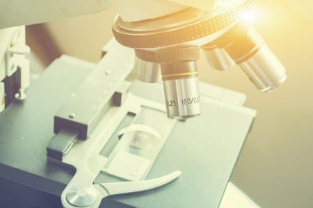 medical laboratory, scientist hands using microscope for chemistry test samples,examining samples and liquid,Medical equipment. microscope,Scientific and healthcare research background.vintage colorの写真素材