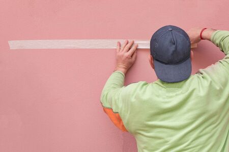 Painters tape paper preparing materials for painting pink walls.selective focusの写真素材