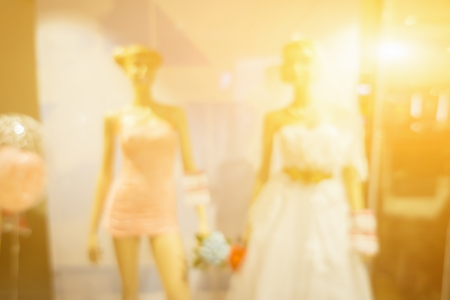 blurred abstract background of multicolored cotton clothing on the shelves of fashion shop and city shopping people crowd at wedding studio shop abstract background.vintage colorの写真素材