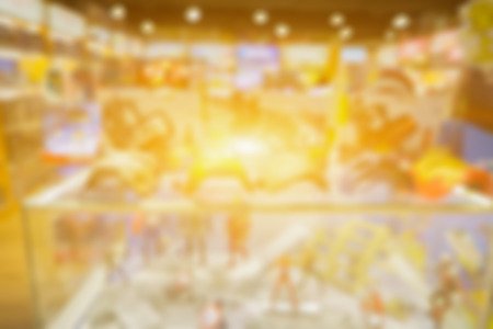 blurred background of toys department store,Natural bokeh shopping mall Toy Store,city shopping people crowd at shopping mall abstract background.vintage color,for displayの写真素材