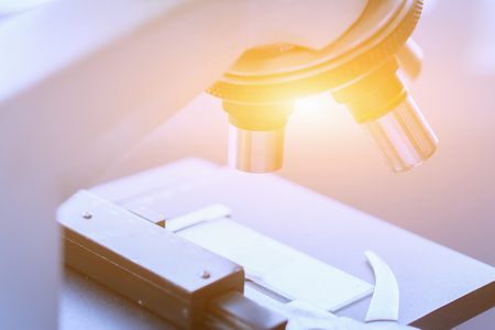 medical laboratory, scientist hands using microscope for chemistry test samples,examining samples and liquid,Medical equipment. microscope,Scientific and healthcare research background.vintage colorの写真素材