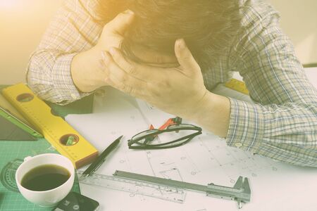 Sad man, Architect working,Office,technology,internet, business,Exhausted businessman falling asleep at his office desk,entrepreneur, trader, tycoon, operator,Frustrated stressed ,vintage colorの写真素材