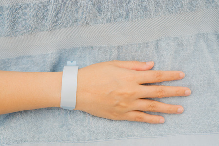 Patient ID Bracelet ,hospital wrist tag,injection in hand,selective focus,vintage color,copy spaceの写真素材