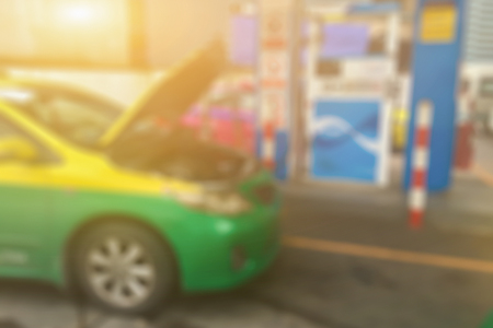 Blurred background of gas station,Car refueling on a petrol station.
oil station pump. Man filling gasoline fuel in car holding nozzle,Gas Station And Convenience Store conceptの写真素材