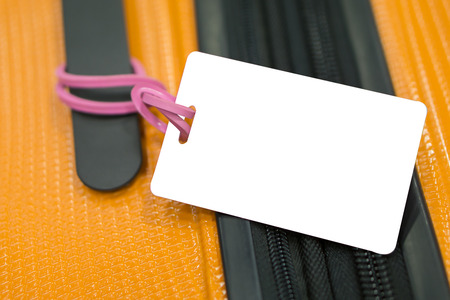 Close up of blank luggage tag label on suitcase or bag with TRAVEL INSURANCE ,Can be used for montage or display your products,selective focus,vintage colorの写真素材