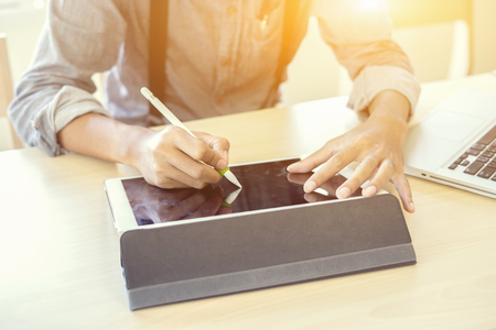 businessmen using tablet and writing business plan for meeting preparation in office.man hand working with new modern laptop computer,tablets and business strategy as concept,selective focus,vintage businessmen using tablet and writing business plan for meeting preparation in office.man hand working with new modern laptop computer,tablets and business strategy as concept,selective focus,vintage