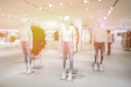 Blur or Defocus image of jeans display in the fashion store,luxury and fashionable brand,blur background of Jeans shirts at shelf in shop, with bokeh for use as Background,vintage retro colorの写真素材
