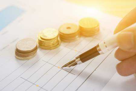 Finances statement with Pen,hand pointing pen on financial charts, paper work in the office,Finance Business,discussing on stock market charts pens pointing at business document during discussionの写真素材