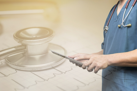 Double exposure of Doctor use tablets computer,Medical Diagnosis And prepare for surgery,doctor recording in microscope, medicine and medical ,doctor  with Stethoscope Health Check with digitalの写真素材