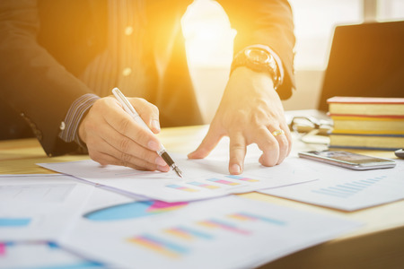 Businessman working,business documents on office table with smart phone and digital tablet and graph financial with social network diagram,laptop computer layer business graph information diagramの写真素材