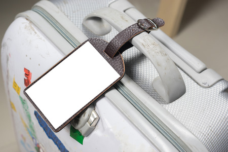Close up of blank Leather luggage tag label on oid suitcase or bag with TRAVEL INSURANCE ,Can be used for montage or display your products,selective focus,vintage colorの写真素材