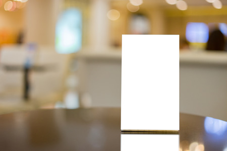 Mock up Menu frame on Table in Bar restaurant ,Stand for booklets with white sheets of paper acrylic...