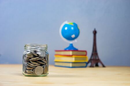 Money and banking concept with coins and jar glass for savings full of medal, dollar, token, piece, specie with filter effect retro vintage styleの写真素材