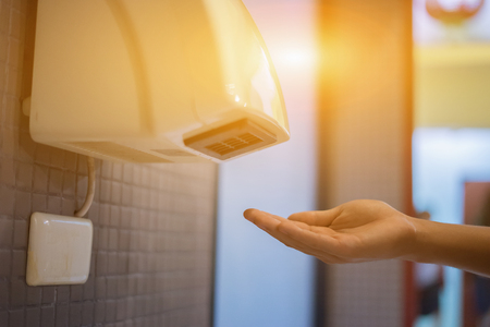 Hand Air Dryer In Public Toilet or Washrooms. selective focus, vintage colorの写真素材