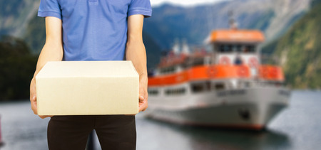 shopping online  and order concept,male postal delivery courier   package to home over General cargo ship mooring at port wait cargo handling from industrial factory riversideの写真素材