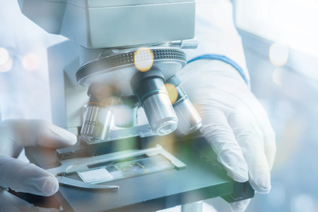 medical laboratory, scientist hands using microscope for chemistry ,biology test samples,examining...