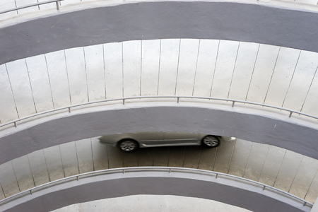 Underground garage parking lot with few cars and empty spaces for more vehicles, urban exploration and geometry in architecture,selective focusの写真素材