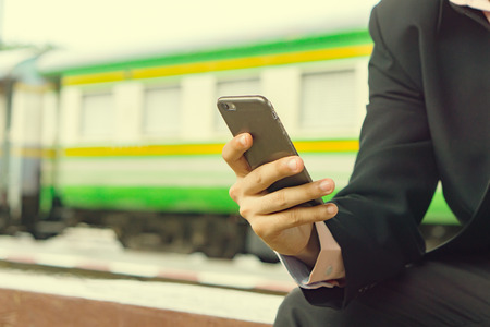 man's hands holding smart phone with blank copy space screen for text message or promotional content,male chatting in network on cell telephone while selective focus,vintage colorの写真素材