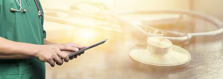 healthcare,Male doctor or medical students or surgeon,anesthesiologists using tablet during the conference,Health Check with digital system support for patient,background bannerの写真素材