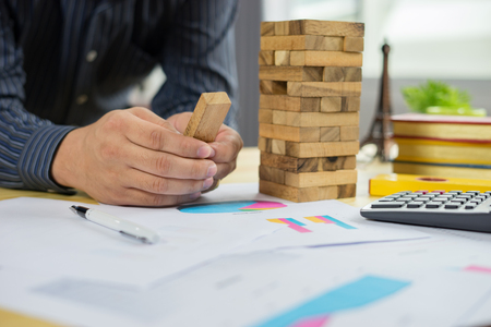 Planning, risk and strategy of project management in business, businessman and engineer gambling placing wooden block on a tower,construction with copy space,selective focus,vintage colorの写真素材